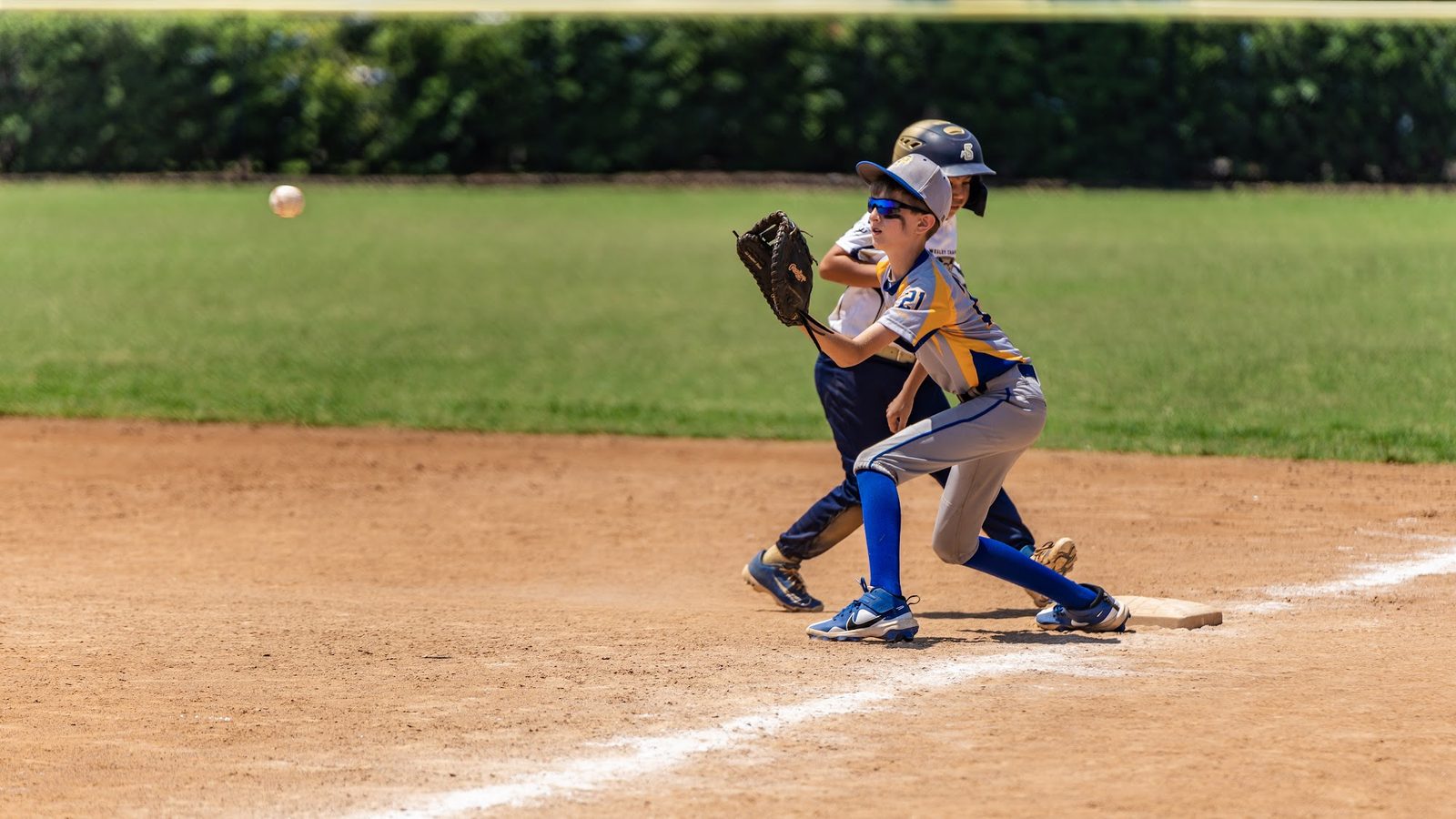 Two children playing baseball on a field