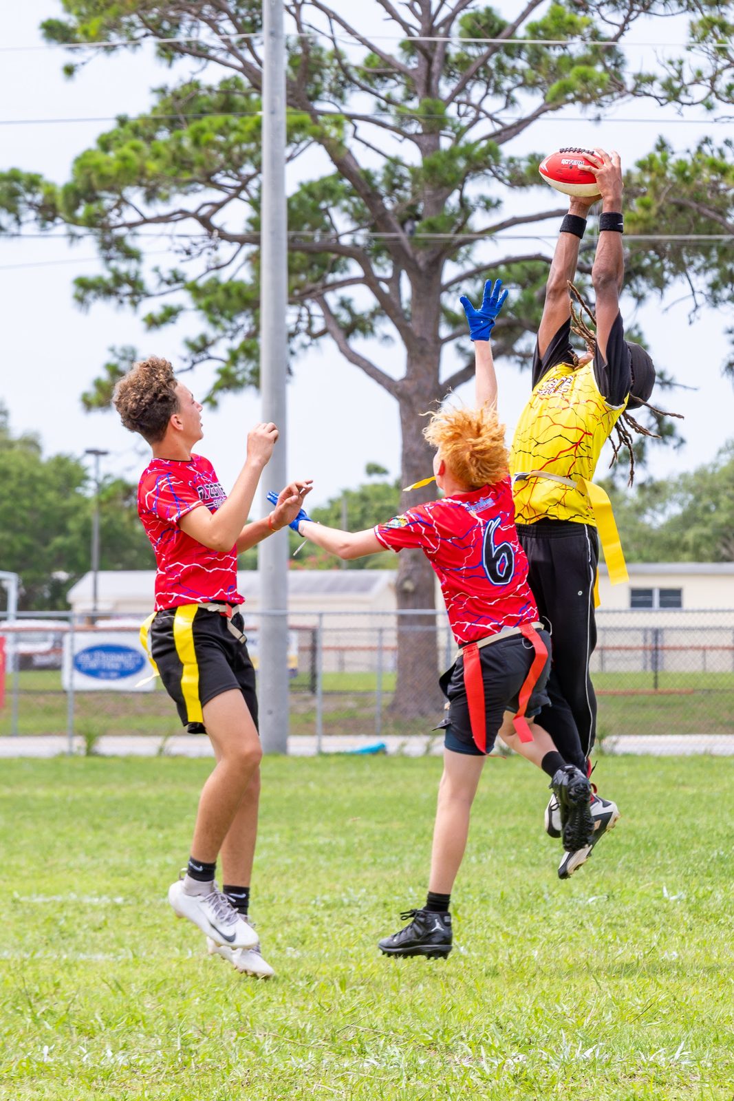 Youth football players competing for a pass in a game