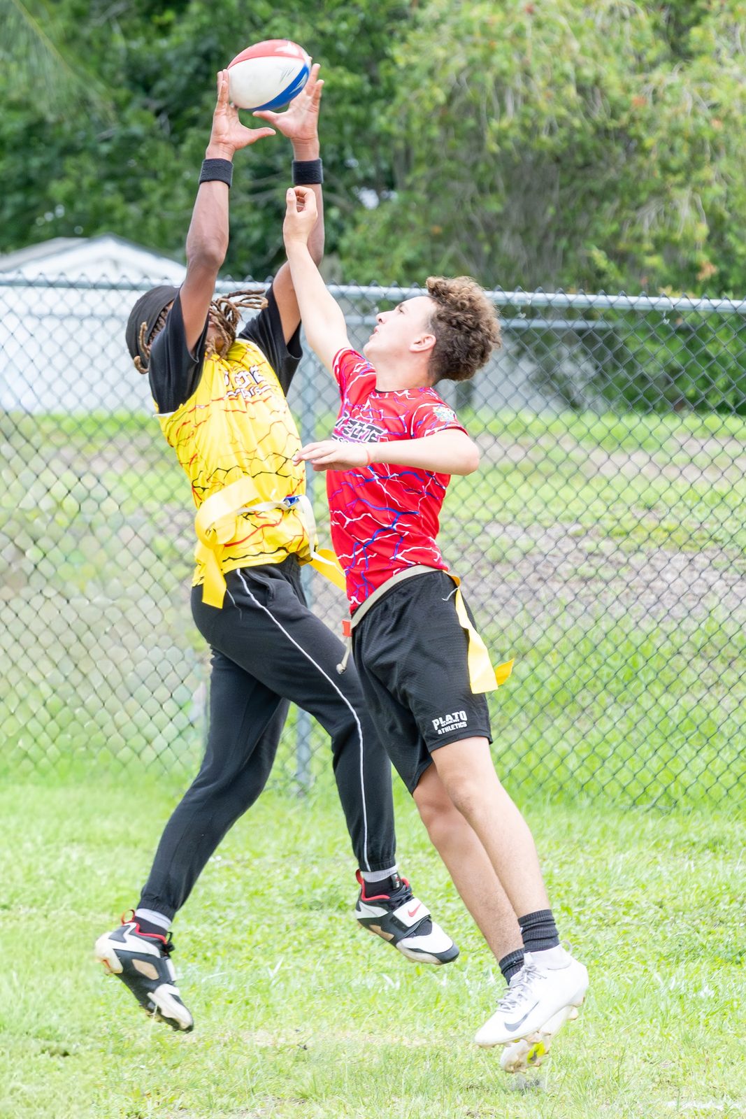 Two players jumping to catch a ball in a sports game