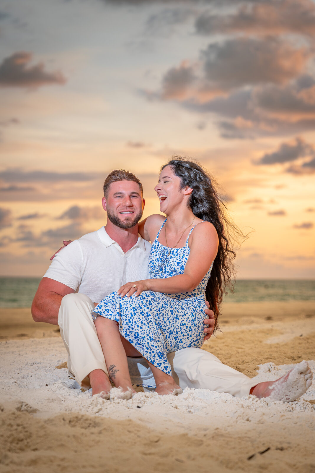 man and woman sitting on the beach
