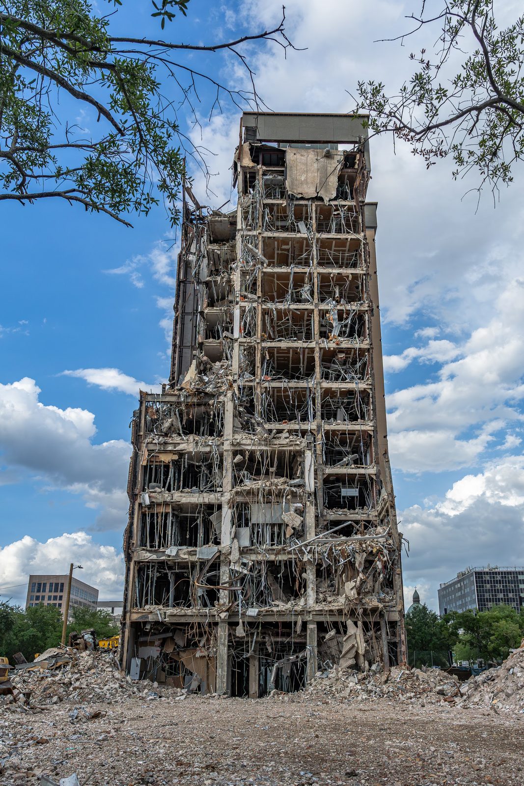 Ruined building with debris and rubble under blue sky