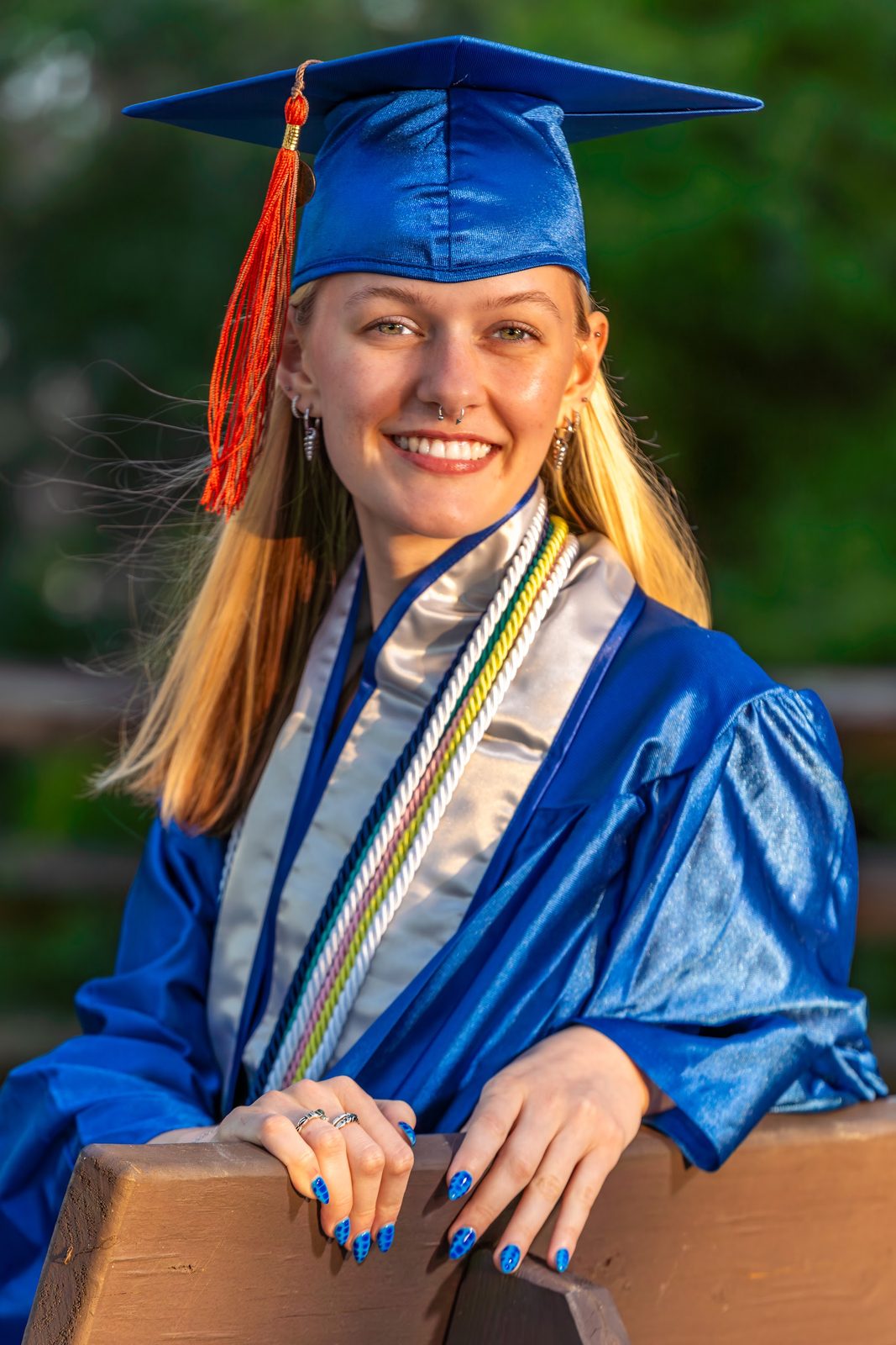 Portrait of a graduate in blue cap and gown