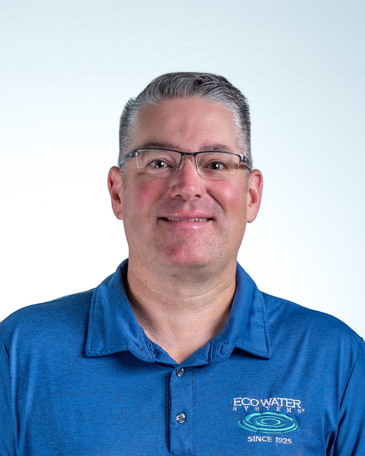 Headshot of a man in blue Eco Water Systems polo shirt