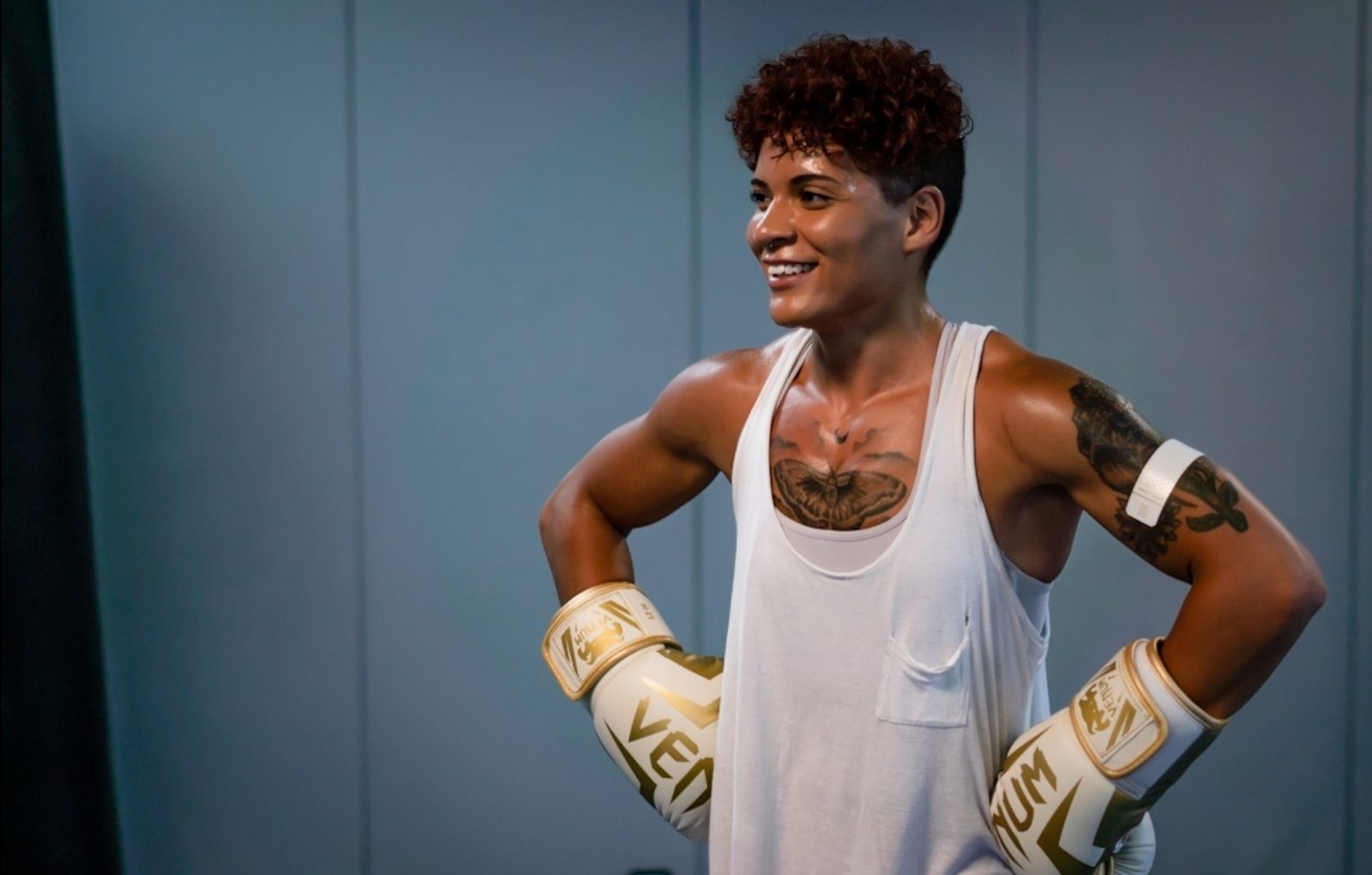 Person in boxing gloves posing with hands on hips